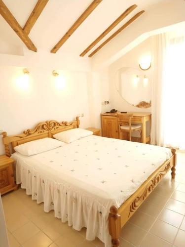 a bedroom with a large bed with a mirror and a table at Park Hotel Amfora -Free Parking in Sofia