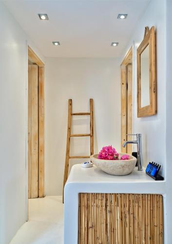 a room with a counter with a bowl of flowers on it at Zefi Hotel & Suites in Naousa