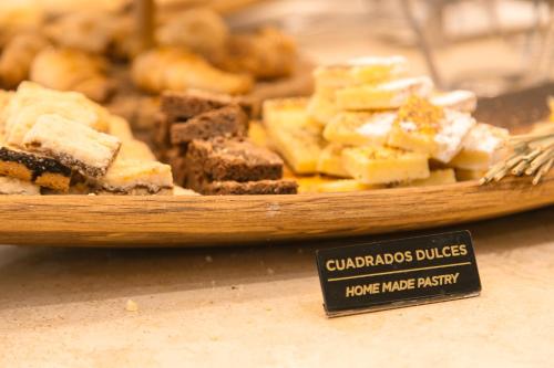 a plate of gingerbread cakes on a table with a sign at Huentala Hotel in Mendoza