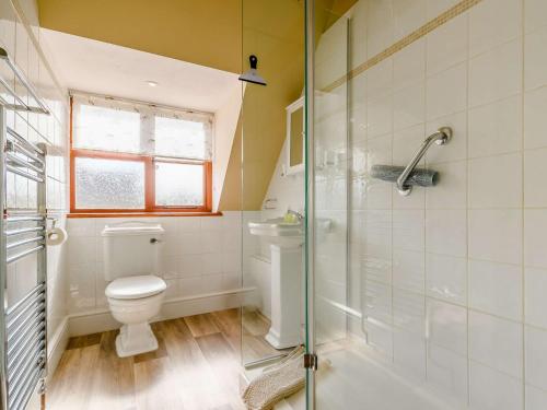 a bathroom with a toilet and a glass shower at 3 Bed in Bretforton 89477 in Bretforton