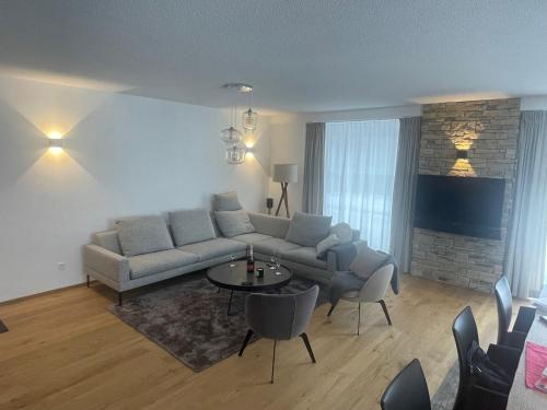 a living room with a couch and a table and chairs at Berghof in Saas-Fee