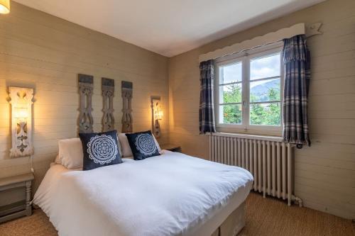 a bedroom with a bed and a window at DIFY Chalet au Coeur de Megeve in Megève