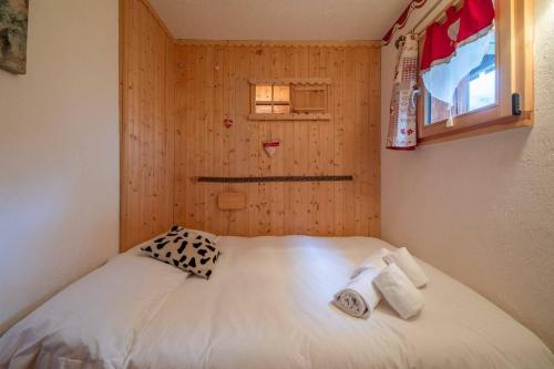 a small bedroom with a bed with towels on it at DIFY Gerets - St Gervais in Saint-Gervais-les-Bains