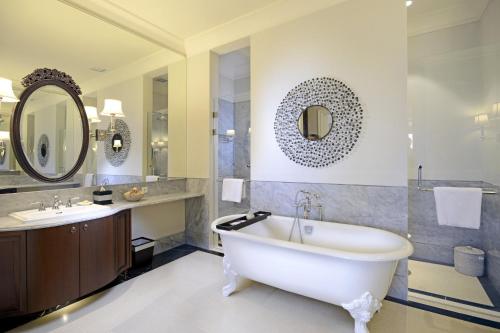 a bathroom with a tub and a sink at Rumah Luwih Bali in Keramas