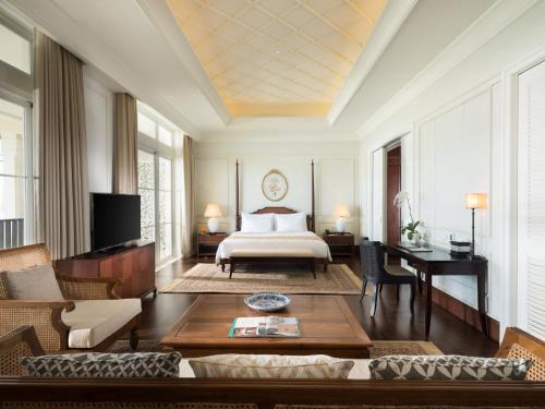a living room with a bed and a table at Rumah Luwih Bali in Keramas