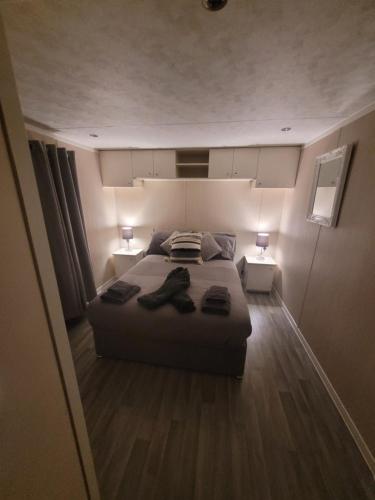 a bedroom with a bed with two night stands and two lamps at Cherry Blossom Retreat in Felton
