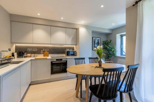 a kitchen with a wooden table and chairs at Apartments in Lake District in Backbarrow