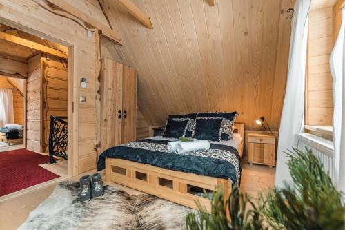 Domek Między Dolinami في فيتوف: غرفة نوم مع سرير في كابينة خشب