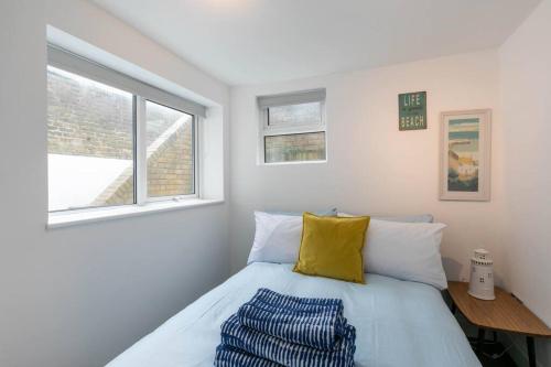 a bedroom with a bed and two windows at Ethlebert Motel; in Margate