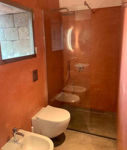 a bathroom with a toilet and a shower and a sink at Nido sul mare in Pantelleria