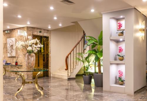 a lobby with a vase of flowers on a table at Ilisia Hotel Athens in Athens