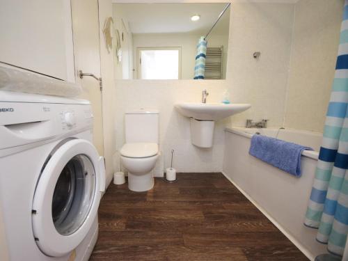 y baño con aseo, lavabo y lavadora. en 1 Bed in Westward Ho ASPRA en Westward Ho