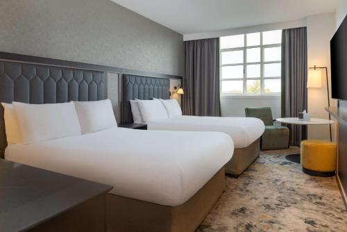 a hotel room with two beds and a window at Hilton Cardiff in Cardiff