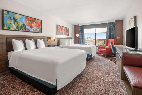 a hotel room with two beds and a television at Hilton Garden Inn Dallas/Allen in Allen