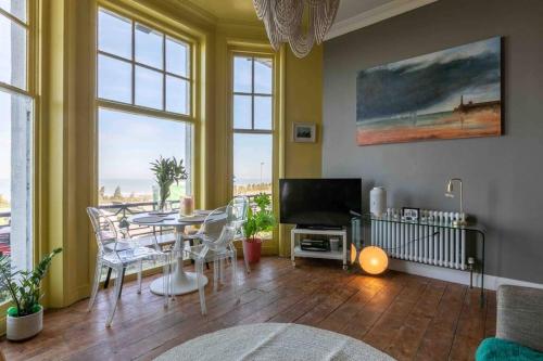 a living room with a table and a television at Bay View - Pet friendly in Margate