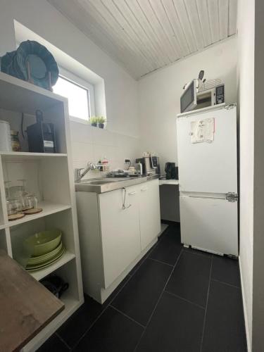 a kitchen with a white refrigerator and a sink at Einliegerwohnung in Taunusstein Bleidenstadt in Taunusstein