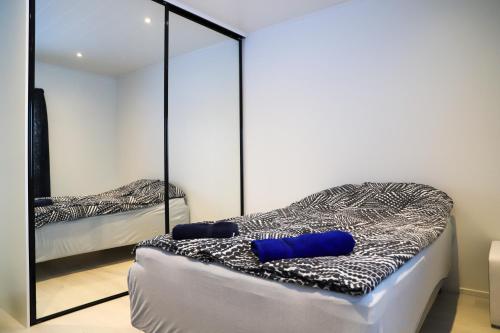 a bedroom with two beds and a mirror at Modern semi-detached house with wonderful location! in Rovaniemi