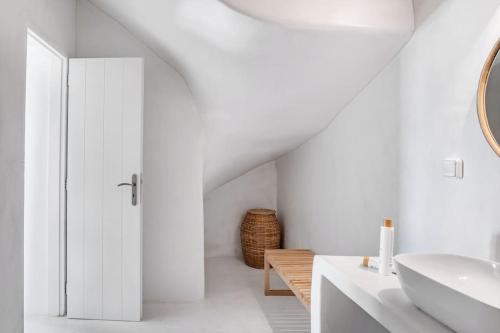 a white bathroom with a sink and a mirror at Horizon House with private pool and breathtaking views in Andiparos