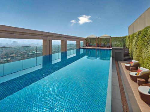 a swimming pool on the roof of a building at Grand Mercure Hanoi in Hanoi