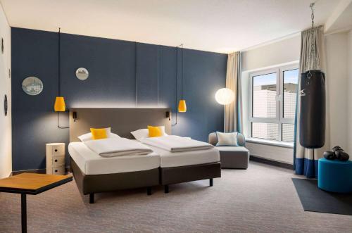 Postel nebo postele na pokoji v ubytování Vienna House Easy by Wyndham Coburg