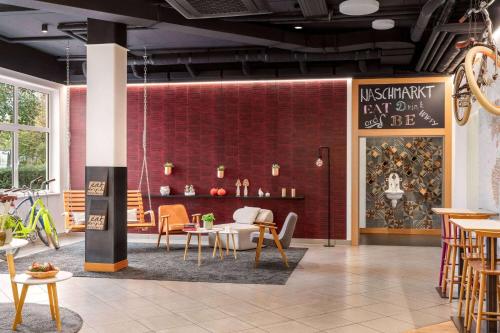 a restaurant with a table and chairs in a room at Vienna House Easy by Wyndham Neckarsulm in Neckarsulm
