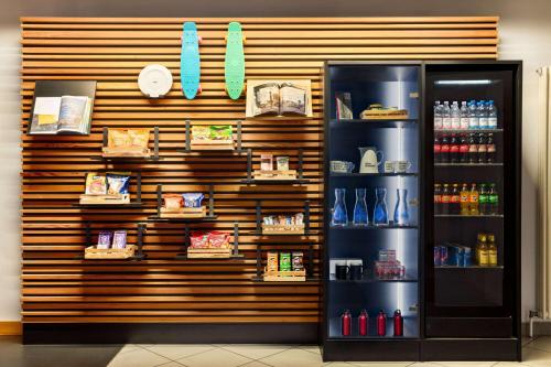a store with a refrigerator in front of a wall at Vienna House Easy by Wyndham Neckarsulm in Neckarsulm