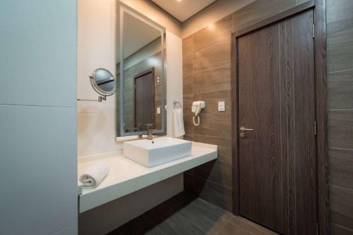 a bathroom with a sink and a mirror at Tryp by Wyndham Asuncion in Asunción