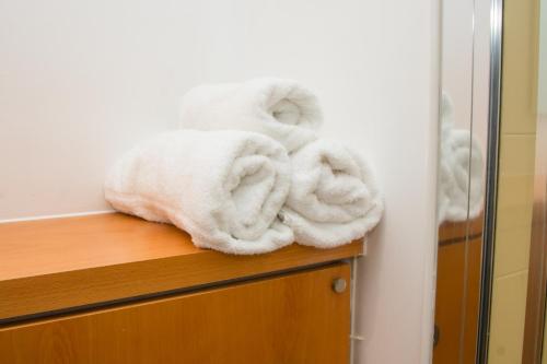a pile of towels sitting on top of a dresser at Blue Harbour Apartments in Edinburgh