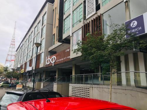 a red car parked in front of a building at FirIzzkey Studio in Kota Bharu