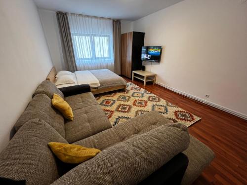 a living room with a couch and a flat screen tv at Apartament Viva Predeal in Predeal