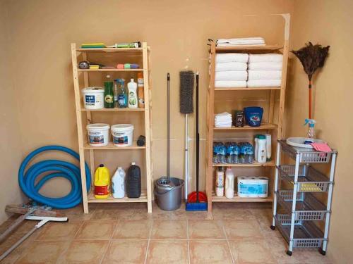 a room with shelves with cleaning products on it at 4-bedroom Villa with pool and barbacue in Elche