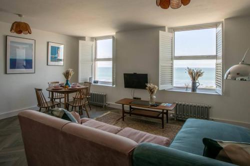 a living room with a couch and a table at Stunning Sea Views @ The Lido Lounge in Margate