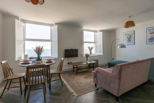 a living room with a couch and a table at Stunning Sea Views @ The Lido Lounge in Margate