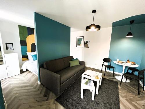 a living room with a couch and a table at La Maison Hugo in Montreuil