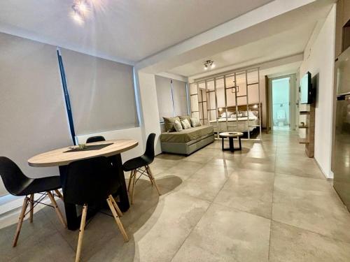 a living room with a table and a couch at Playa Grande Apartment in Mar del Plata