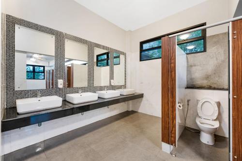 a bathroom with three sinks and two mirrors at Chill Inn Samui Hostel and Restaurant in Koh Samui 