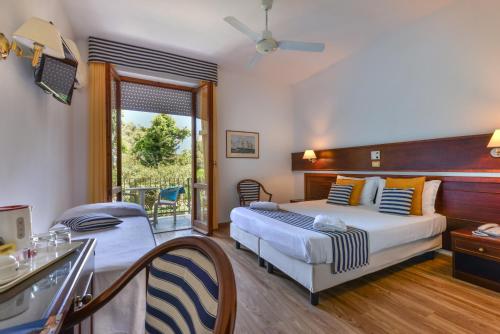 Postel nebo postele na pokoji v ubytování Hotel Le Acacie
