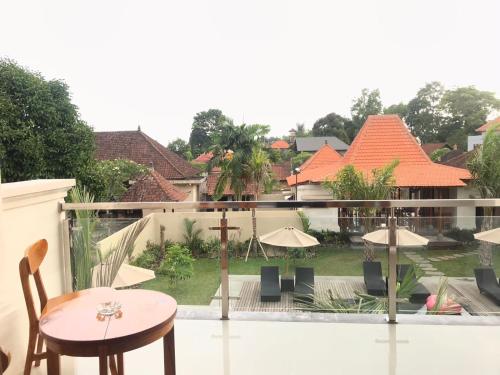a view of a balcony with a table and chairs at Londo House in Ubud