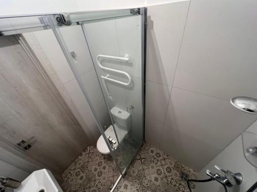 a bathroom with a toilet and a glass shower stall at Міні-готель "Старовокзальний" in Kyiv
