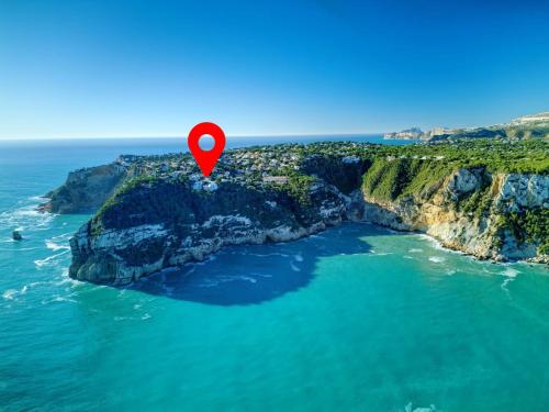 a rock in the ocean with a red marker on it at Villa Batavia by Interhome in Balcon del Mar