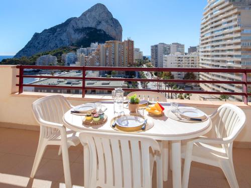 a white table with two chairs on a balcony at Apartment Zafiro 02 by Interhome in Calpe