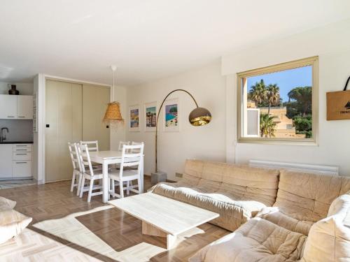 a living room with a couch and a table at Apartment Cadet Rousse-6 by Interhome in Le Lavandou