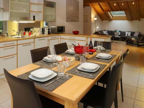 Apartment Brigitte by Interhome في زيرمات: طاولة طعام مع كراسي ومطبخ