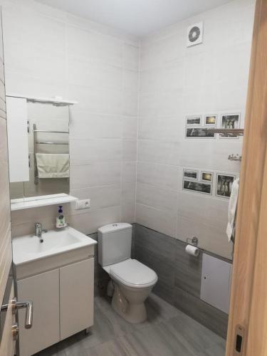 biała łazienka z toaletą i umywalką w obiekcie VIP apart 505 w mieście Tsqnetʼi