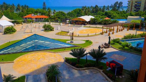 an aerial view of a park with a swimming pool at PALM VILLAGE BUSINESS HOTEL in Dar es Salaam