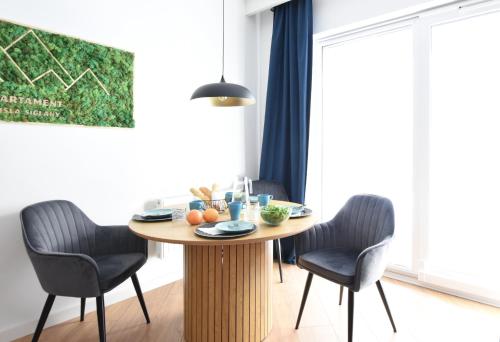 a dining room with a table and two chairs at Apartament Wisła Siglany in Wisła