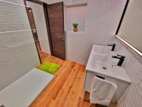 a bathroom with a sink and a shower at -Le Zen Spa+Jacuzzi+Parking+Clim in Colmar