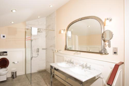a bathroom with a sink and a shower and a mirror at Boyne House Slane in Slane