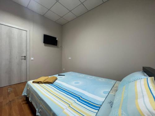 a bedroom with a bed and a flat screen tv at Міні-готель "Старовокзальний" in Kyiv