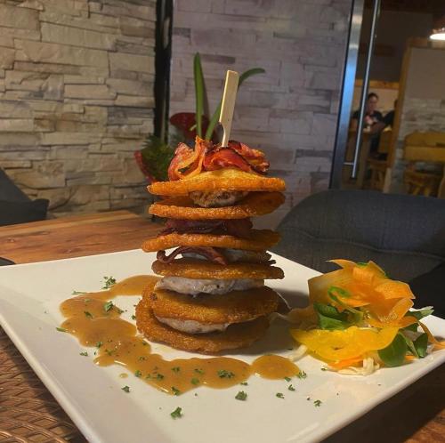 a stack of food on a plate on a table at Hotel Taurus in Ostrava